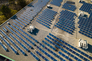 Solar power station panels on the school roof building at golden hour. Green energy at hazy sunset....