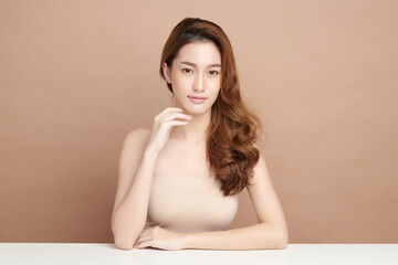 Naklejka premium Beautiful young asian woman with clean fresh skin on beige background, Face care, Facial treatment, Cosmetology, beauty and spa, Asian women portrait.