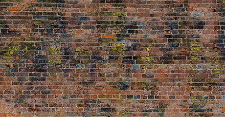 Mixed black, yellow, brown, red, blue old bricks wall panorama background pattern 