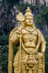 Fototapeta premium Lord Murugan statue in front of Batu Caves in Gombak, Selangor, which is one of the most popular Hindu shrines outside India.