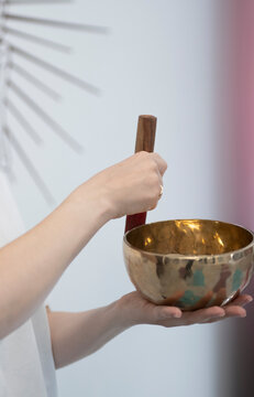Extracting sound from a Tibetan singing bowl. High quality photo