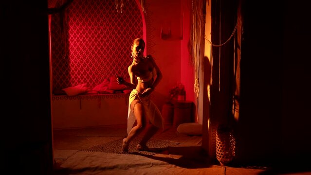 beautiful woman is dancing oriental choreography, exotic dance show in harem in ancient palace