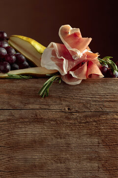 Prosciutto with rosemary, pear, and grapes.