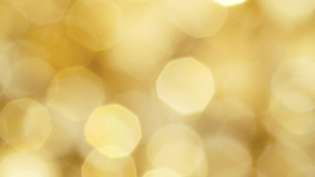 Blurred golden abstract background, bokeh Christmas holiday decoration design