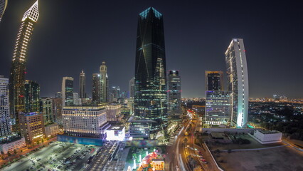 Panorama of Dubai International Financial district night timelapse. Aerial view of business and financial office towers.