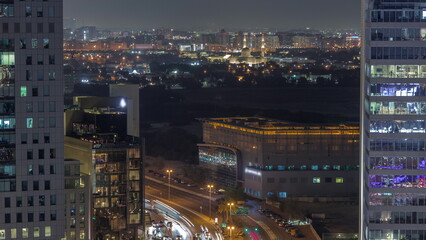 Skyline view of traffic on Al Saada street near DIFC district night timelapse in Dubai, UAE.