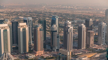 Fototapeta na wymiar Jumeirah Lakes Towers district with many skyscrapers along Sheikh Zayed Road aerial timelapse.