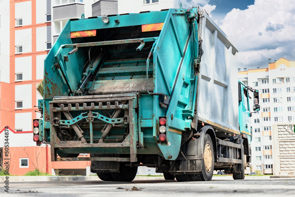 Leinwandbilder a garbage truck picks up garbage in a residential area. loading mussar in containers into the car. s