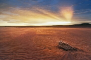 Sunset, Beams in the sky of Khakassia Oglakhty mountains. reservoir without water, sandy ripples, clay and hills, rainy sky over Mount Tepsey Tepsei