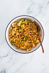 healthy plant-based food, vegan spicy chickpeas broccoli and cauliflower stir-fry with peanut sauce