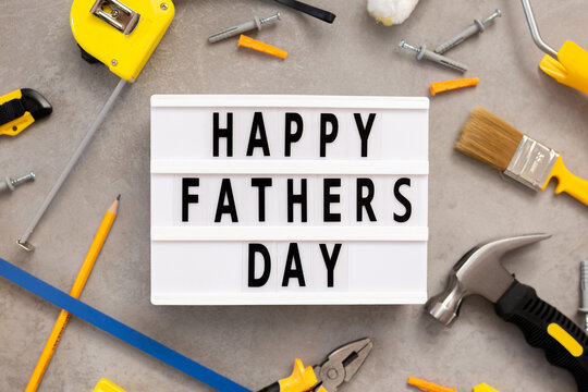 Father's Day lightbox message with tools for repair saw nippers hammer . top view flat lay. I love dad
