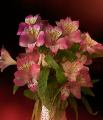 a bouquet of orchid flowers stands in a vase