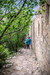 Fototapeta na wymiar woman in a blue jacket trekking in the Caucasus mountains