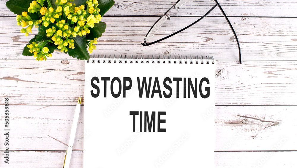Poster stop wasting time text concept write on notebook on wooden background