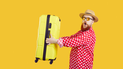 Funny chubby traveler going on holiday. Side view of fat man in red polka dot shirt, summer hat and...