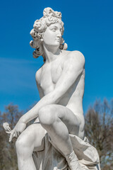 Old statue of a sensual Italian renaissance or rococo era hunter in Potsdam city park, Germany,...