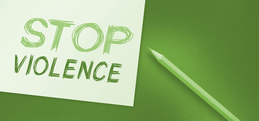 stop violence text write on paper with orange pencil. No discrimination social concept