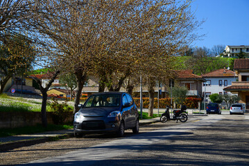 Beautiful view of city street with parked cars on sunny day