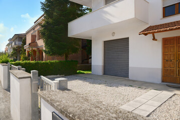 Fototapeta na wymiar Modern apartment building with yard on sunny day