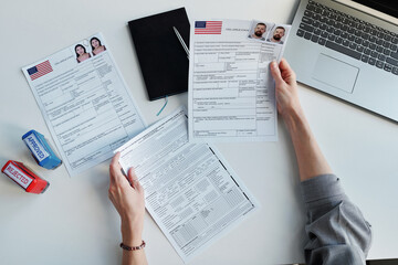 Top-down view shot of unrecognizable woman working in US embassy working with travel visa...