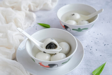 Shop bought festive cuisine. Tangyuan aka Sweetened Glutinous Black Sesame Ball Soup. Eaten during lantern festival, wedding, family reunion and in winter solstice