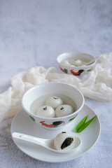 Shop bought festive cuisine. Tangyuan aka Sweetened Glutinous Black Sesame Ball Soup. Eaten during lantern festival, wedding, family reunion and in winter solstice