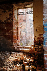 Window with beaming sunlight in a red brick wall. Ruined wall of an antique Russian church.