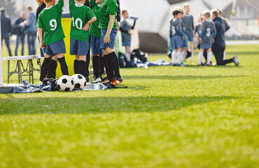 Youth soccer football team. Group photo. Soccer players standing together united. Soccer team huddle. Teamwork, team spirit and teammate example. - obrazy, fototapety, plakaty
