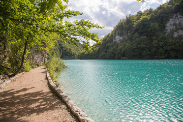 Plitvice Lakes National Park, Croatia, Europe: A sidewalk along the beautiful turquoise water of a...