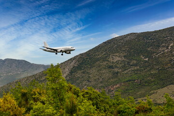 White airplane landing in Dubrovnik airport (Cavtat).