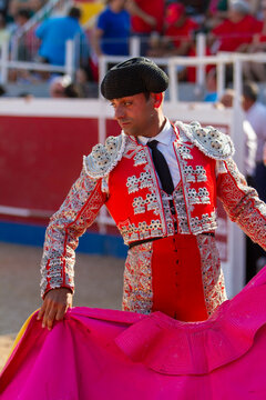 a Spanish bullfighter practices with his capote moments before the bullfight