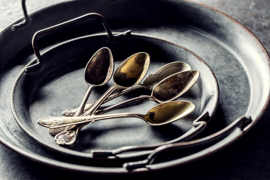 Antique trays with spoons on a rustic table