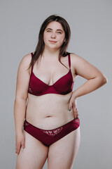 fat pretty smiling girl in red lingerie. catalog photo. home response concept. oversize. size plus
