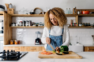 Woman preparing food in kitchen.