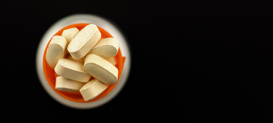 magnesium taurate pills banner. dietary concept close-up. dietary supplement topview on black...