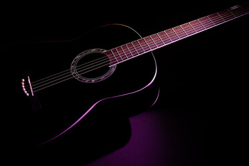 Obraz na płótnie Canvas black guitar isometric view close-up. guitar music low-key concept