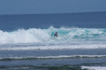 Fototapeta na wymiar Surfing in Ujung Bocur