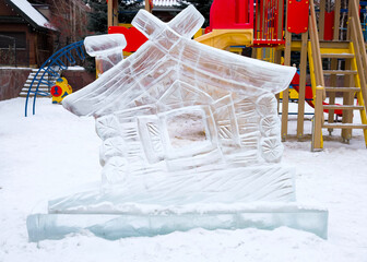 Ice house on the playground. Ice carving