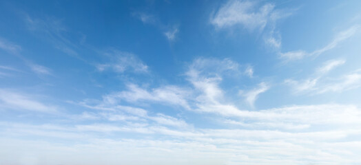 Wide angle photo of sunny and windy weather sky with blue tones. Summer or spring sky with...