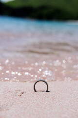 Fototapeta na wymiar Wedding ring on the sand of Pink Beach