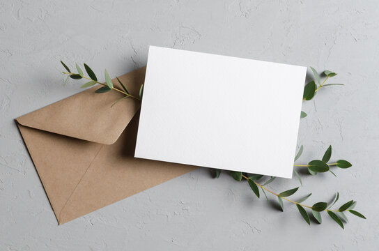 Save the date card or invitation mockup with envelope and fresh eucalyptus twigs