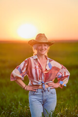 portrait of a middle-aged woman in the wheat field at sunset