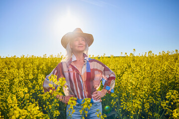 Portrait of a middle-aged woman in the rapeseed chain.