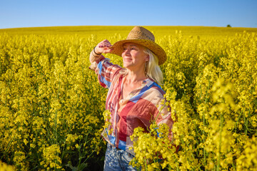 Portrait of a middle-aged woman in the rapeseed chain.