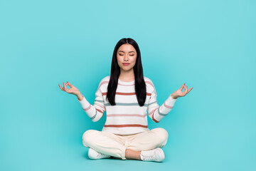 Photo of adorable calm peaceful young woman practice mindfulness open her chakras isolated on...
