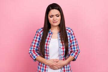 Portrait of unsatisfied person hands stomach feel bad isolated on pink color background