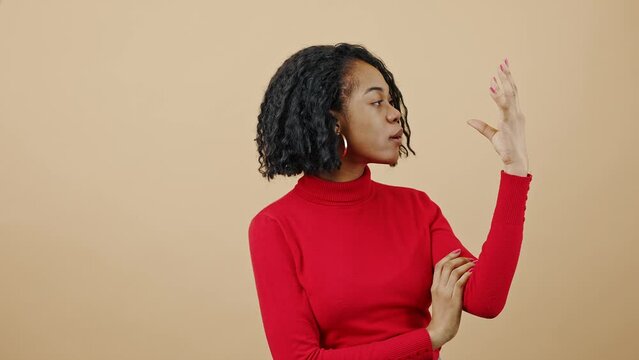 Empty talks concept. Young tired african american woman feeling bored of fake news, gesturing blah blah gesture