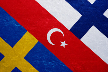 Flags of Turkey, Sweden and Finland on the concrete wall