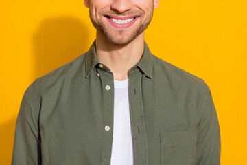 Cropped view portrait of attractive cheerful glad guy healthy white teeth isolated over vivid yellow color background