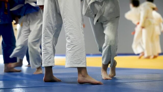 Children do a judo grip. Legs close-up